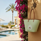 Day Off Tote in Tropic Lime hanging from a wall hook by a villa pool