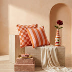 Cherry on Top vase in Sunset Coral on a travertine plinth