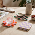 Me Time coasters, all three colours, on a breakfast table